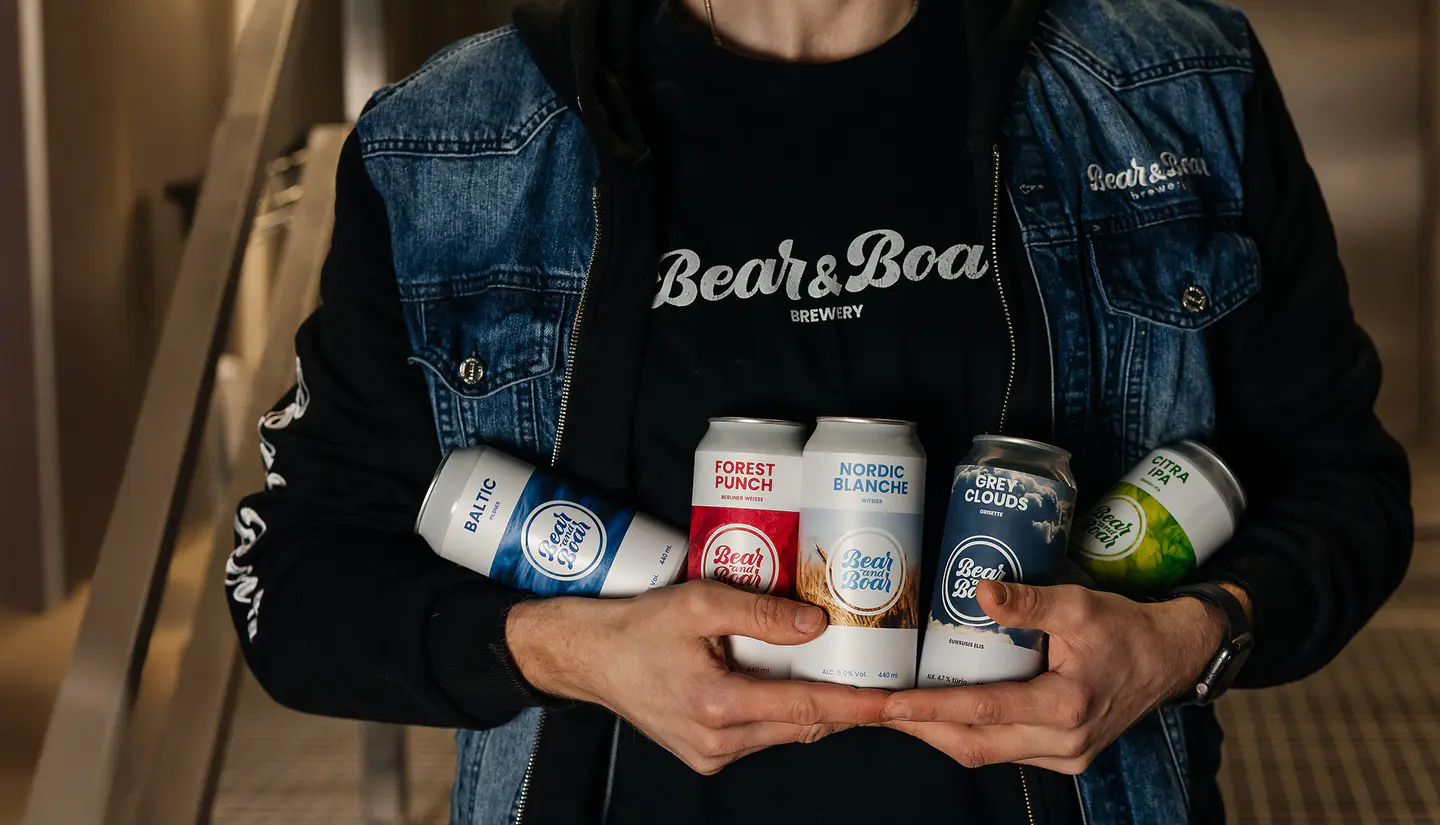 A person wearing a shirt and drinks branded "Bear and boar"